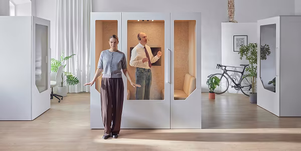 People looking for available meeting space in a co-working environment
