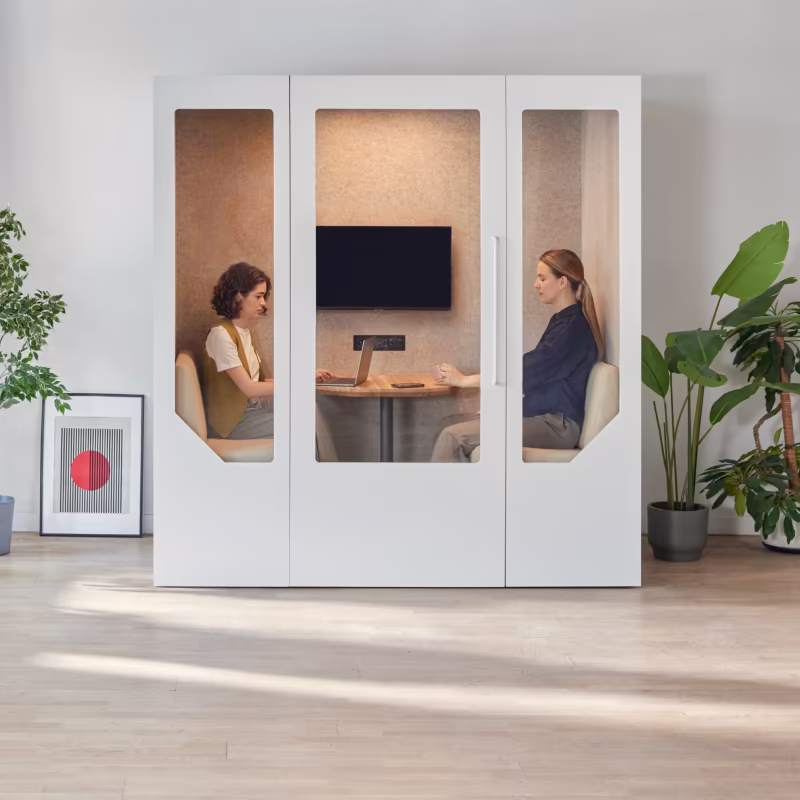 Employees having a meeting inside a Persy office phone booth designed for private conversations