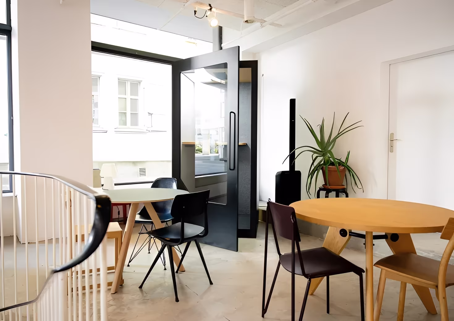 Modern office workspace combining collaboration areas with soundproof pods for focused work