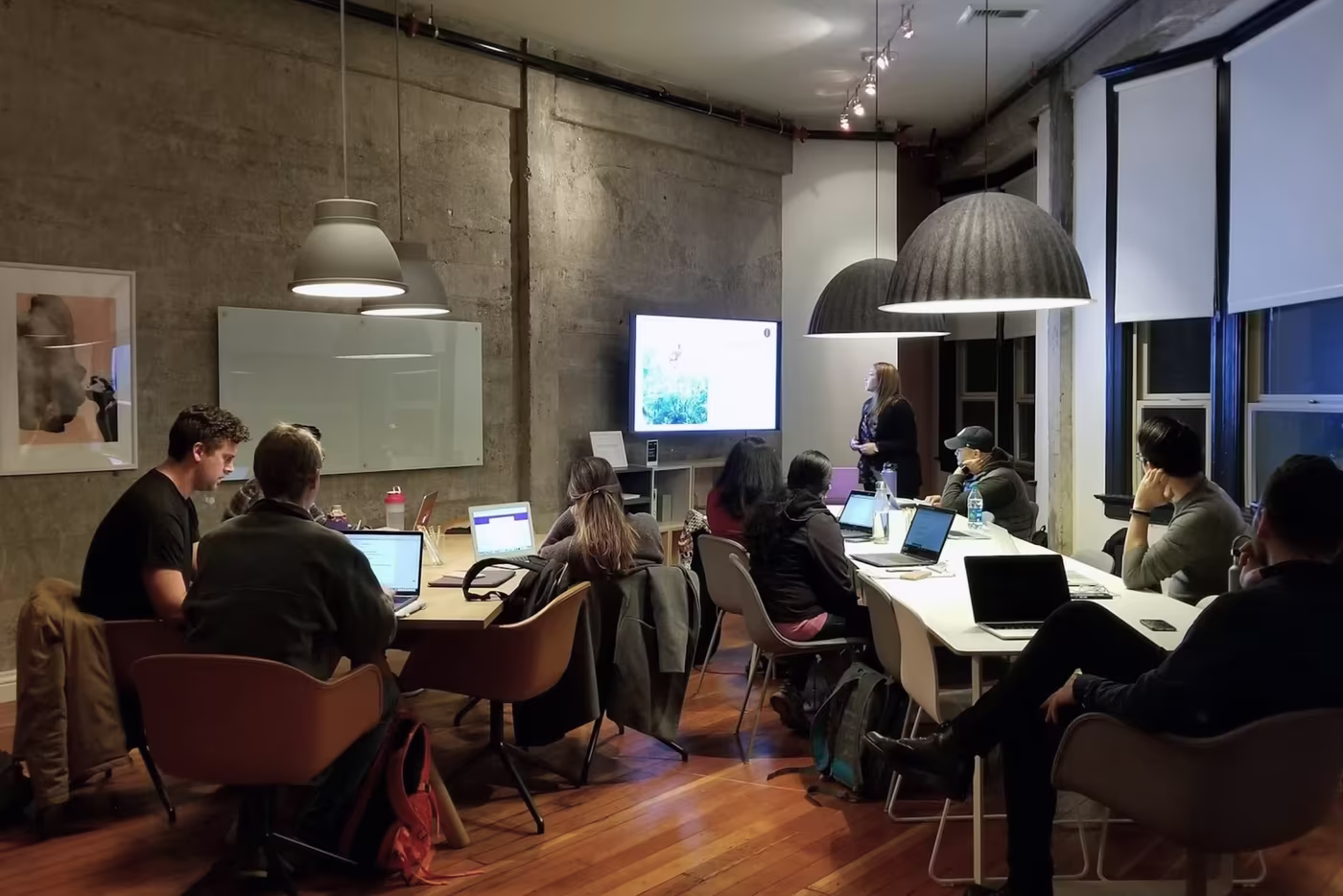 Modern coworking space with wooden meeting pod, exposed brick walls, and stylish lounge seating