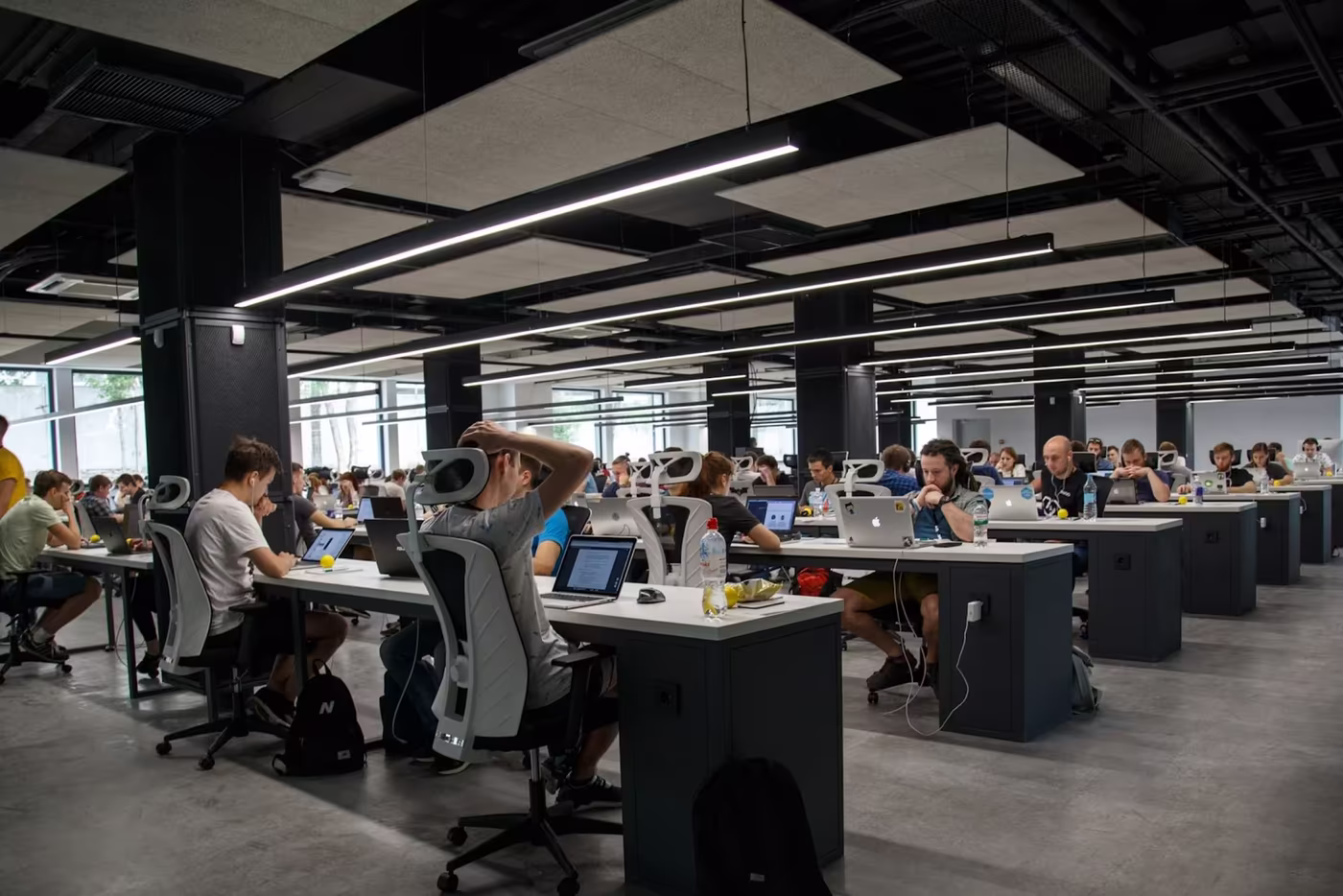 Open workspace office with multiple teams working in a shared environment