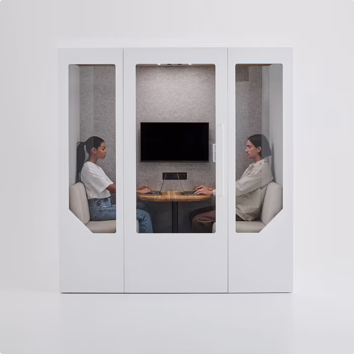 Open office with soundproof booth for private work, featuring modern furniture, plants, and exposed wooden ceiling