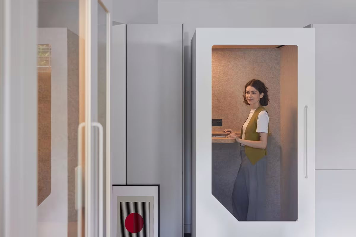Woman using a Persy soundproof office pod for focused work