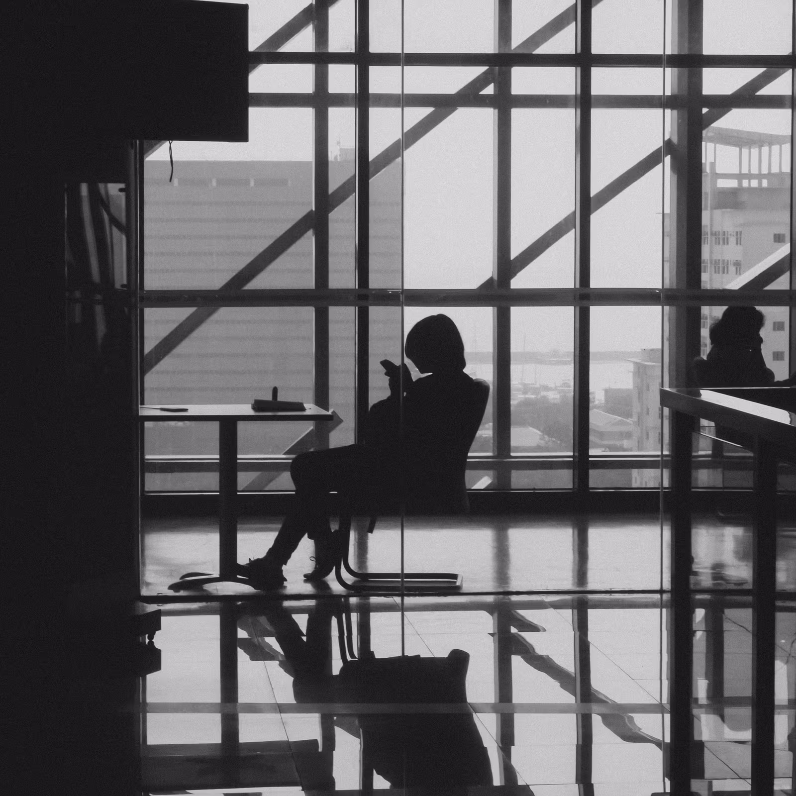 Employee working alone at a quiet window seat away from the main office floor