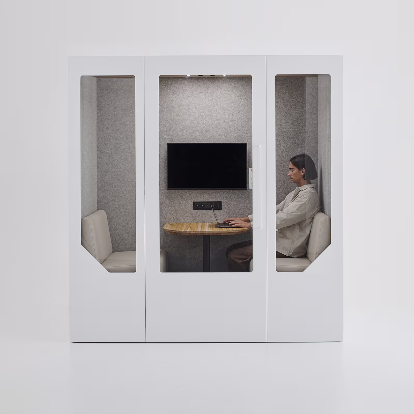 Person working on a laptop inside a Persy meeting pod