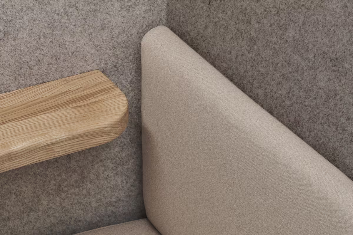 Acoustic felt walls and cushioned seat inside a Persy booth