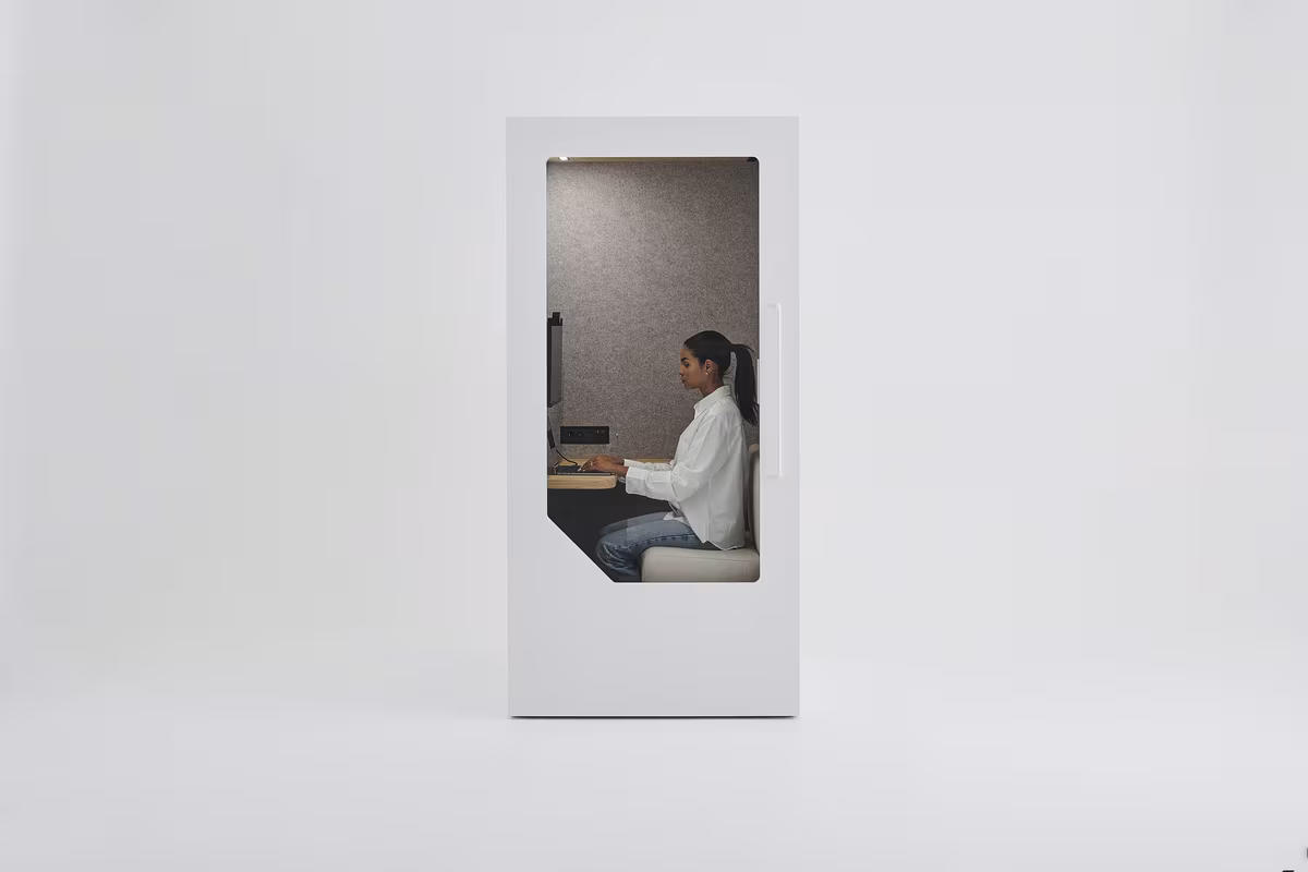 Woman working at the desk inside a Persy One phone booth