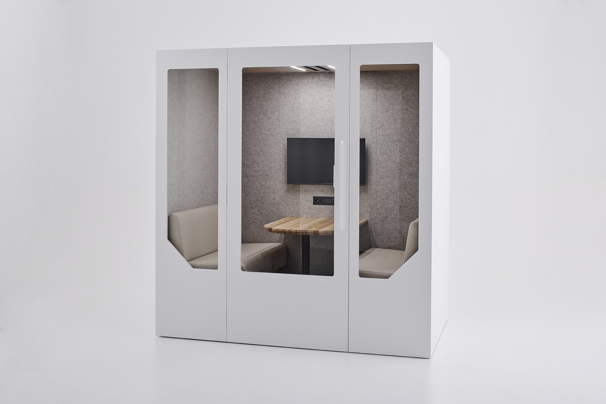 White Persy Four acoustic meeting booth with glass panels, grey felt interior, built-in seating, wooden table, and wall-mounted screen.