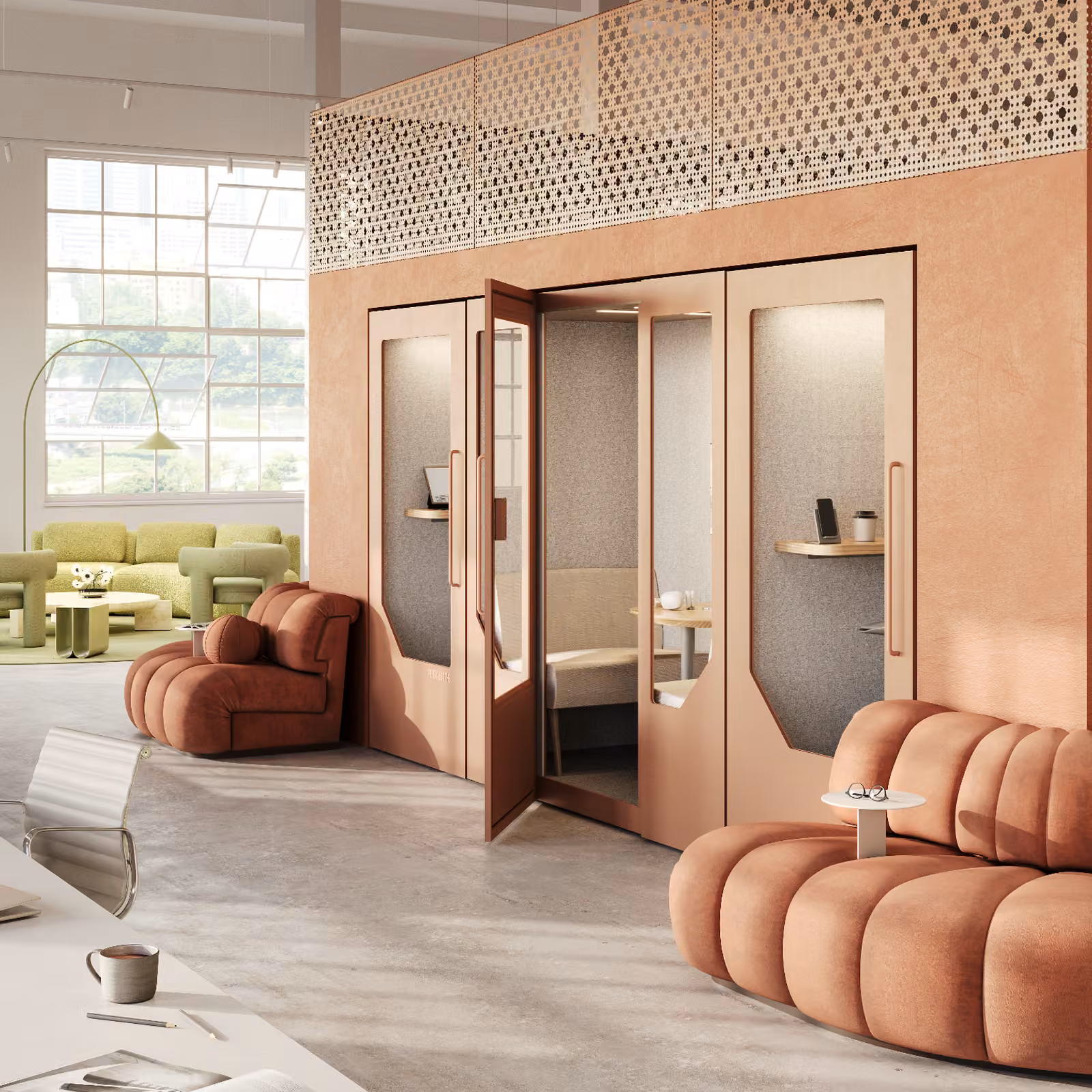 Modern office interior with terracotta acoustic phone booths, soft lounge seating, large windows, and contemporary workspace furniture.