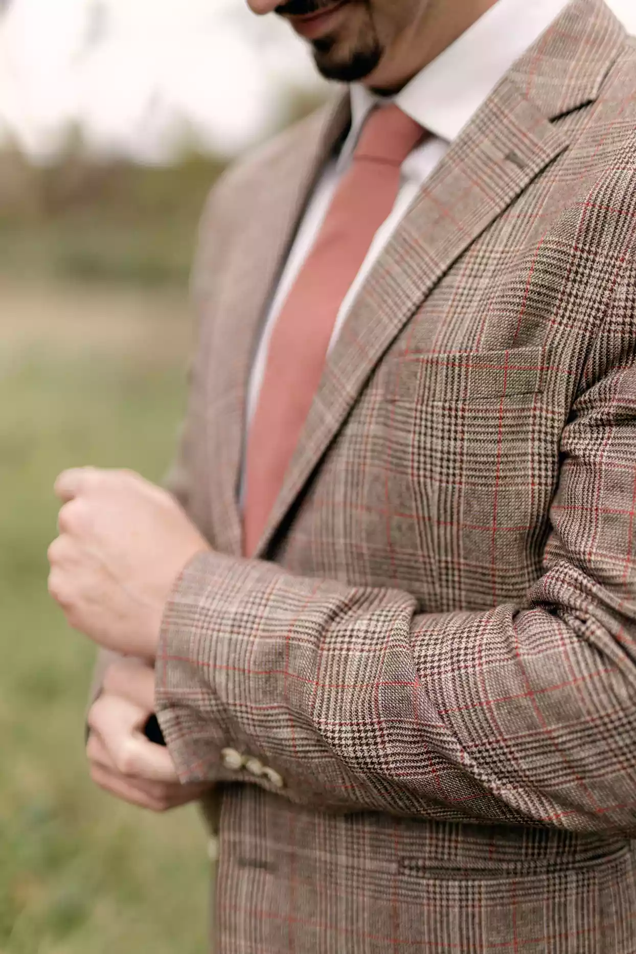 groom wearing brown checkered tweed suit