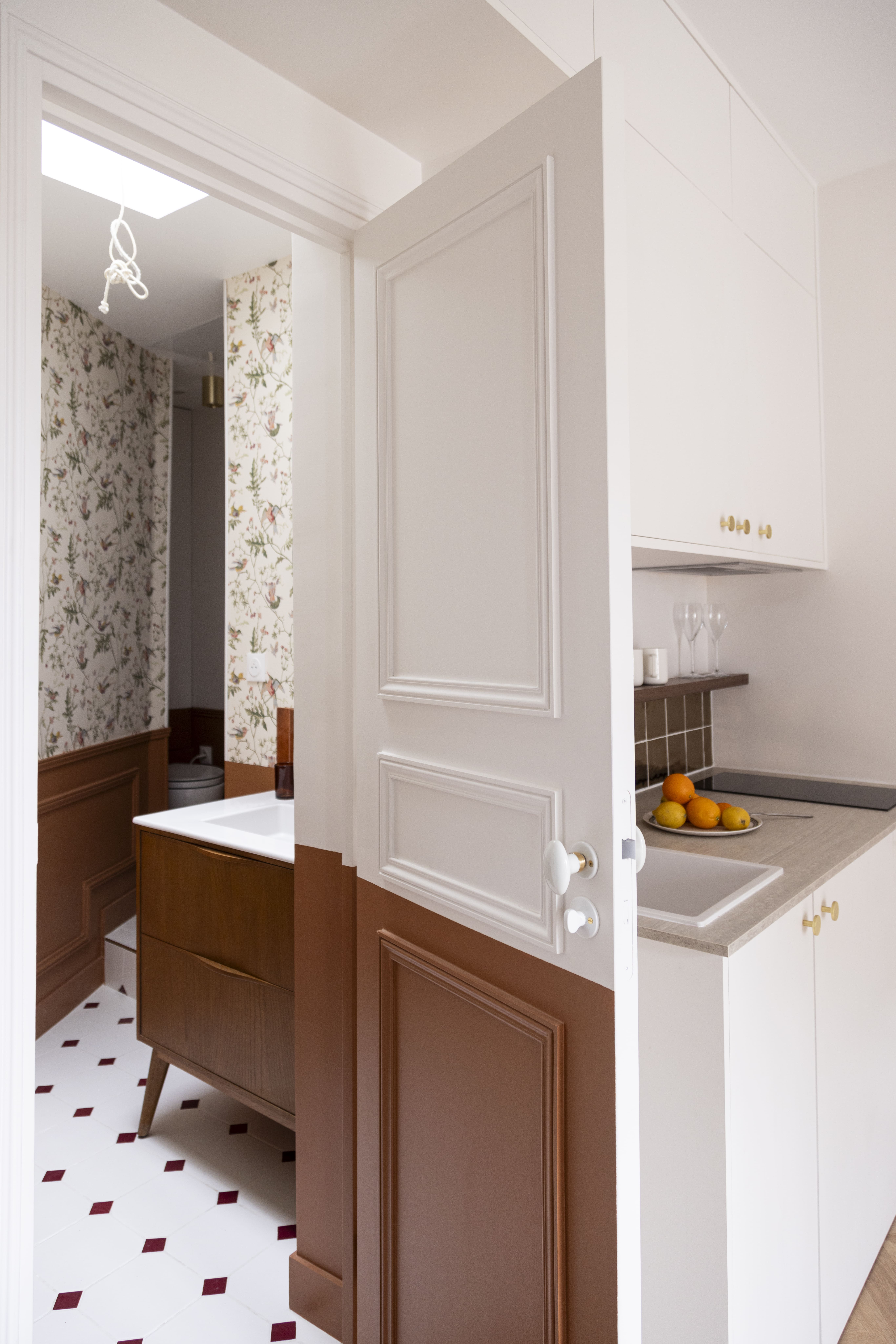 Salle d’eau rénovée avec papier peint floral et meuble vasque en bois