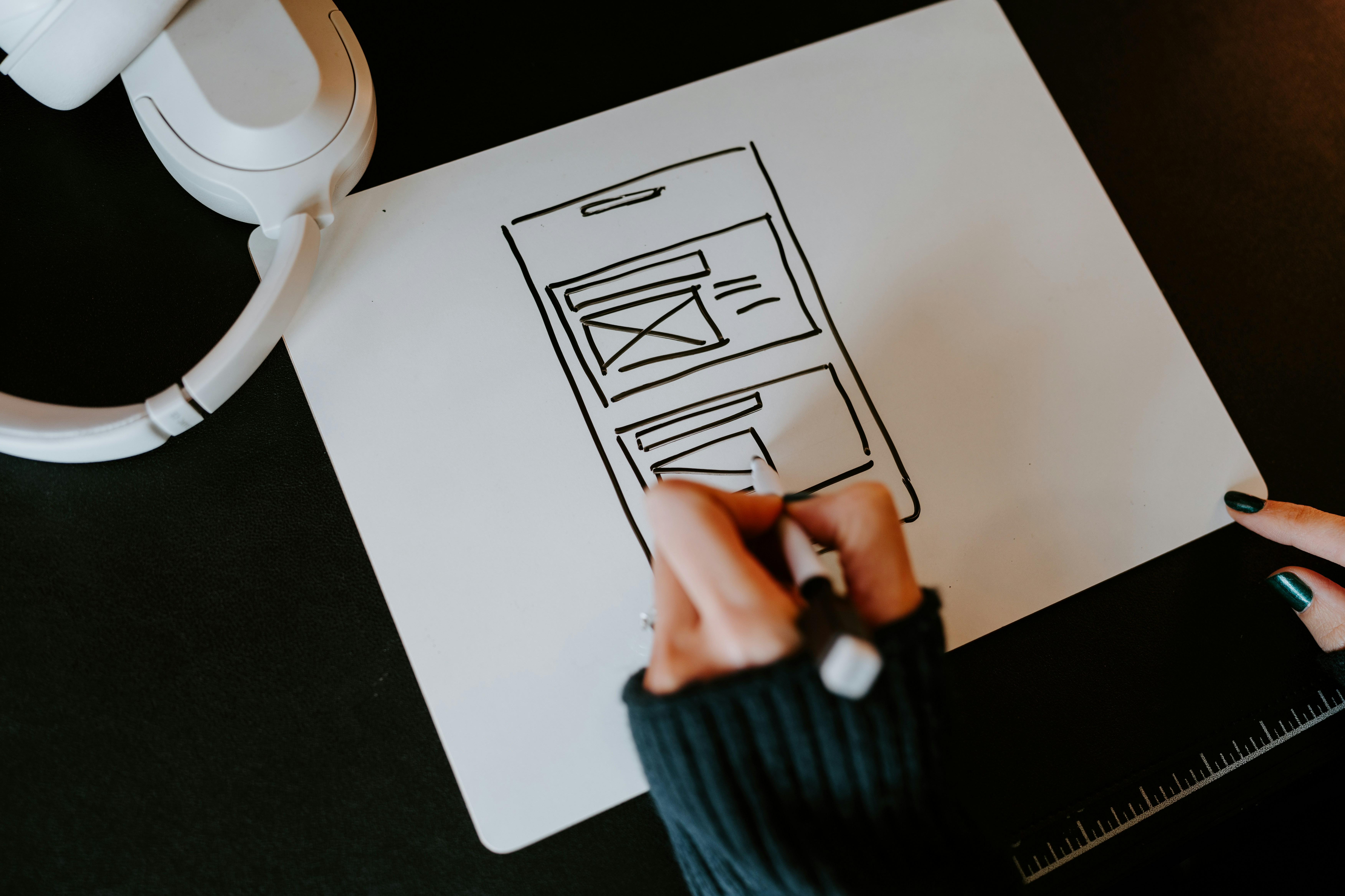 Woman sketching a mobile wireframe.