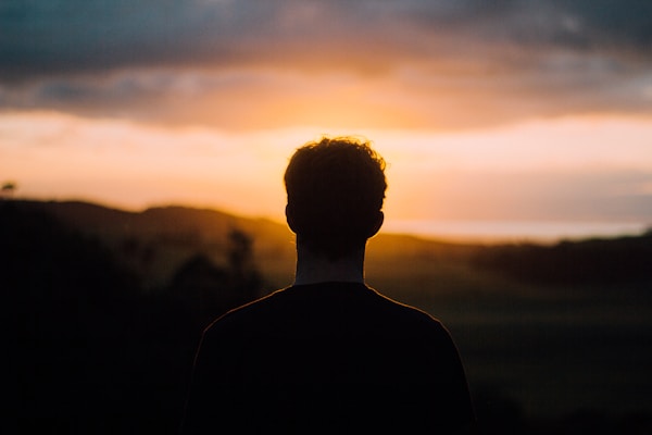 Man watching Muriwai sunset