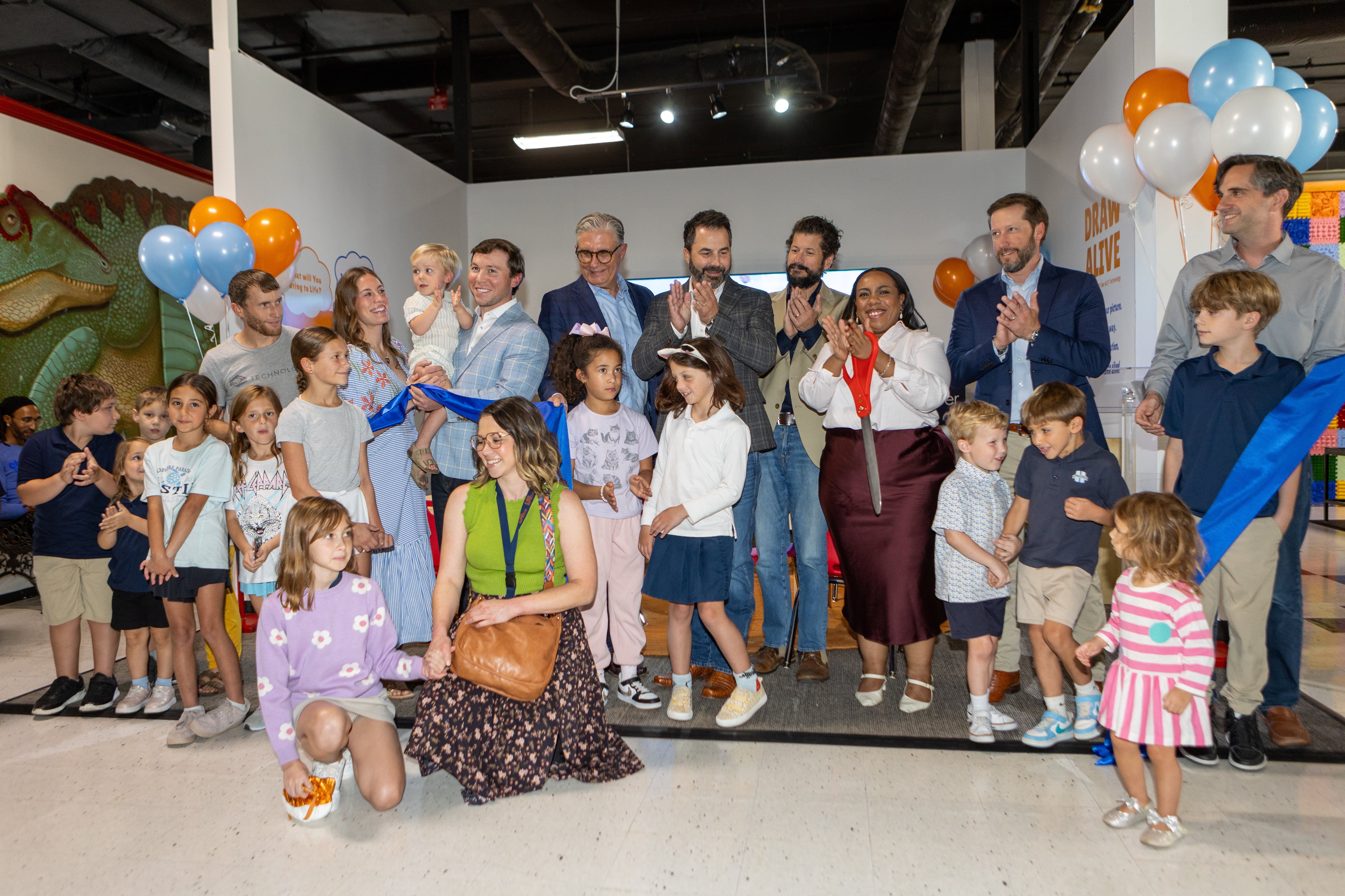 Children, families and community partners celebrate the opening of the Draw Alive exhibit at the Children's Museum of Acadiana.