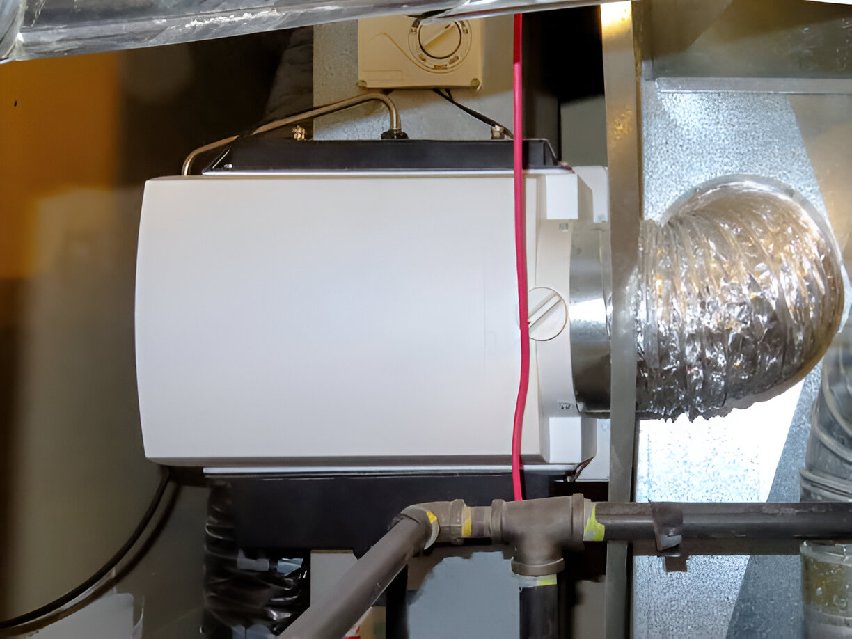 White electrical device with pipes and flexible duct in mechanical room
