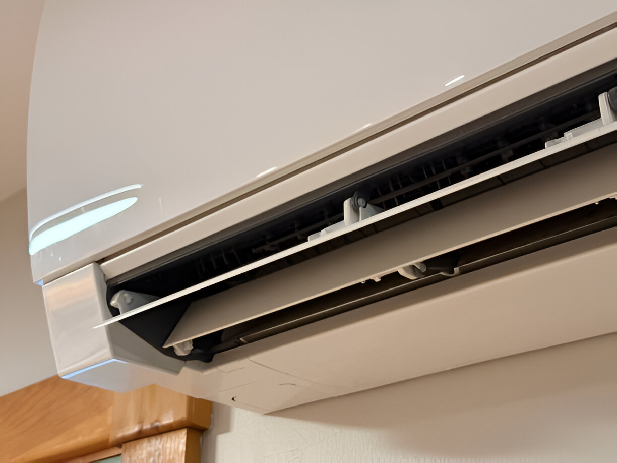 Wall-mounted air conditioning unit with white and black design
