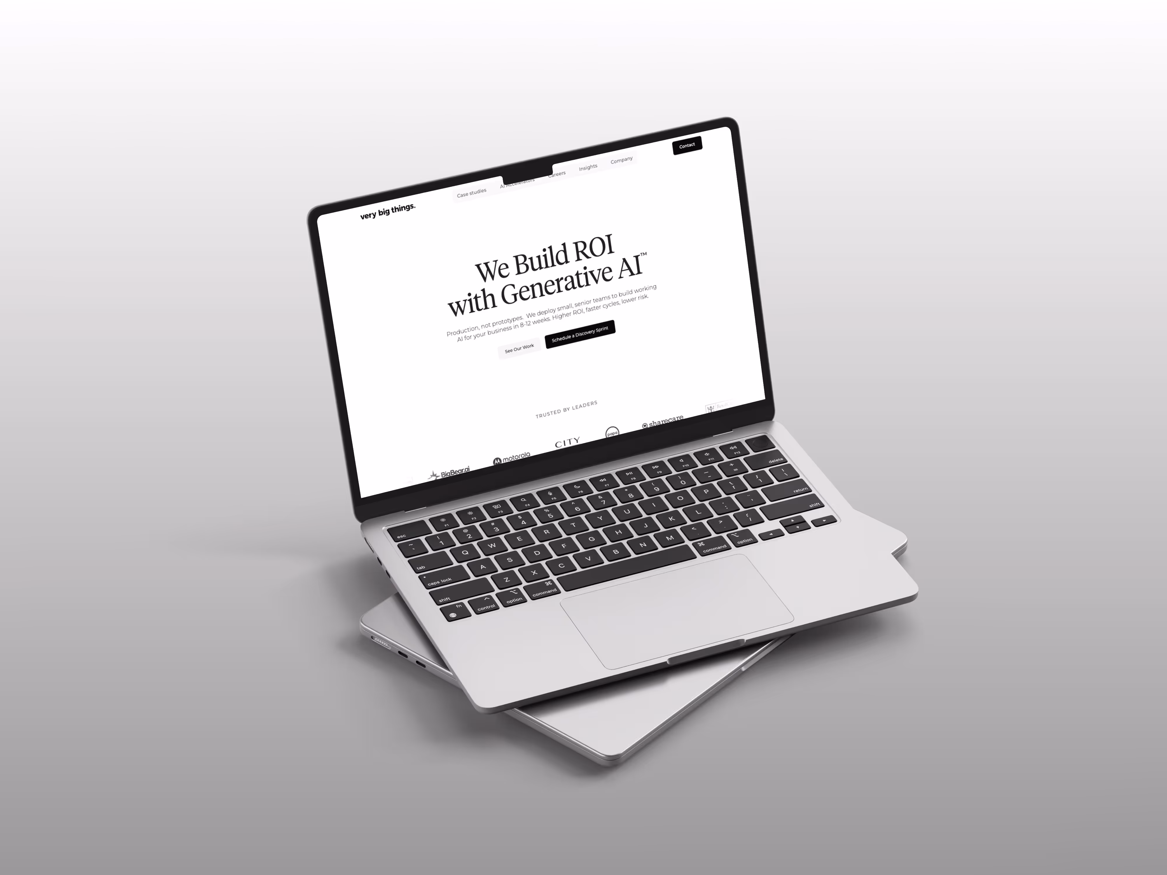 Silver laptop open displaying a website homepage about building ROI with generative AI against a gray gradient background.