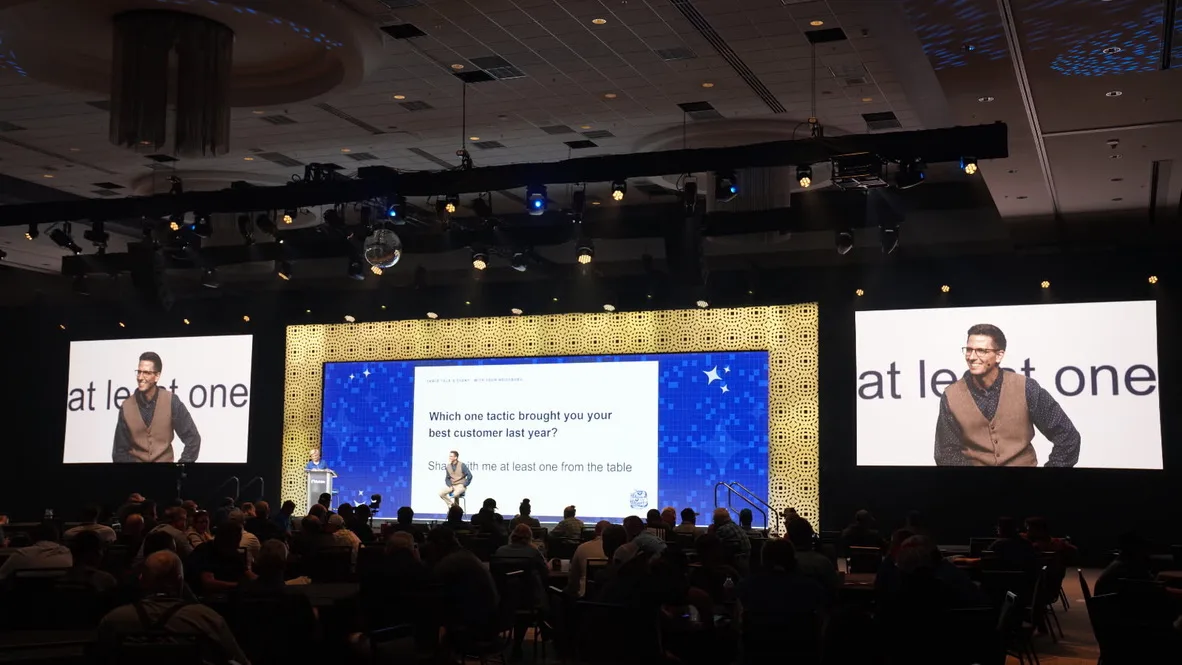 Cody Bailey presenting to a full ballroom at a dealer convention