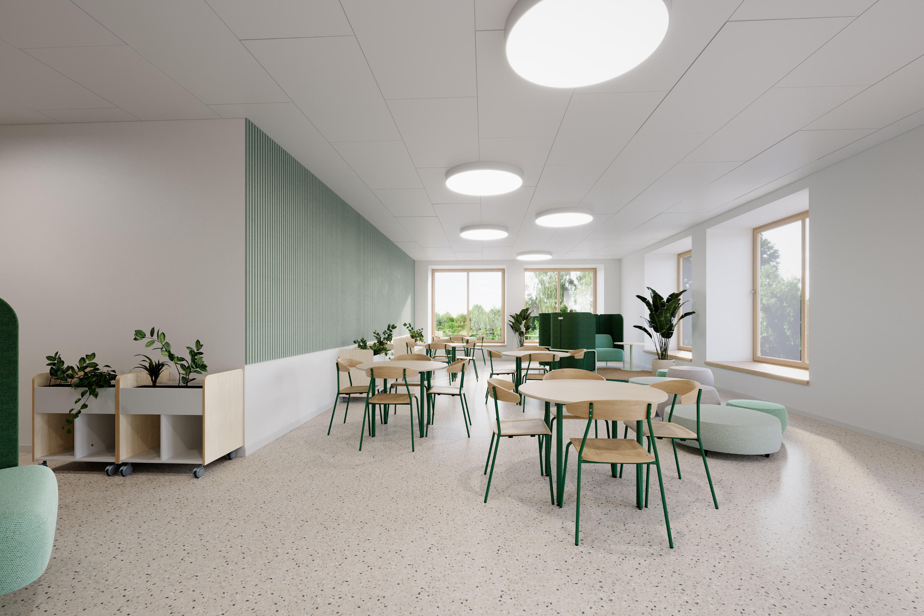 Ein Schülercafé in einer Aula mit verschiedenen Sitzmöglichkeiten an Tischen und Loungemöbel.