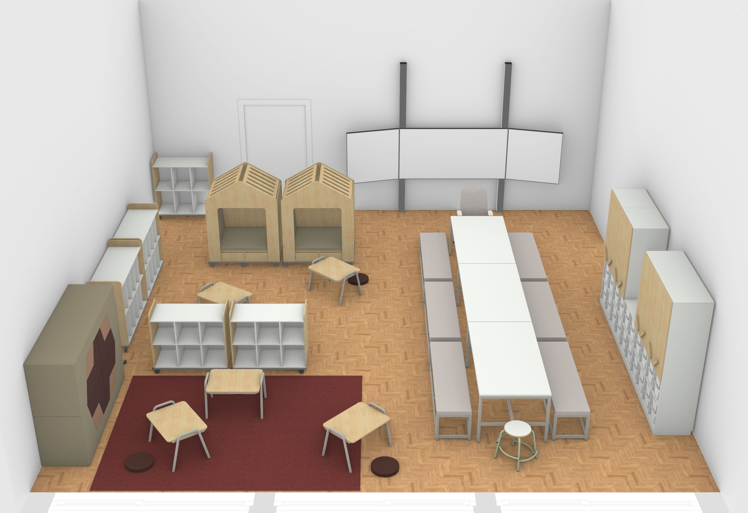 Auf der rechten Seite des Klassenzimmers stehen Schränke und große Tische, die mit gepolsterten Bänken zu einer langen Tafel gestellt sind. Im anderen Bereich befinden sich ein Teppich, Rollcontainer, zwei Rückzugshäuser sowie gestapelte Sitzpolster an der Wand.