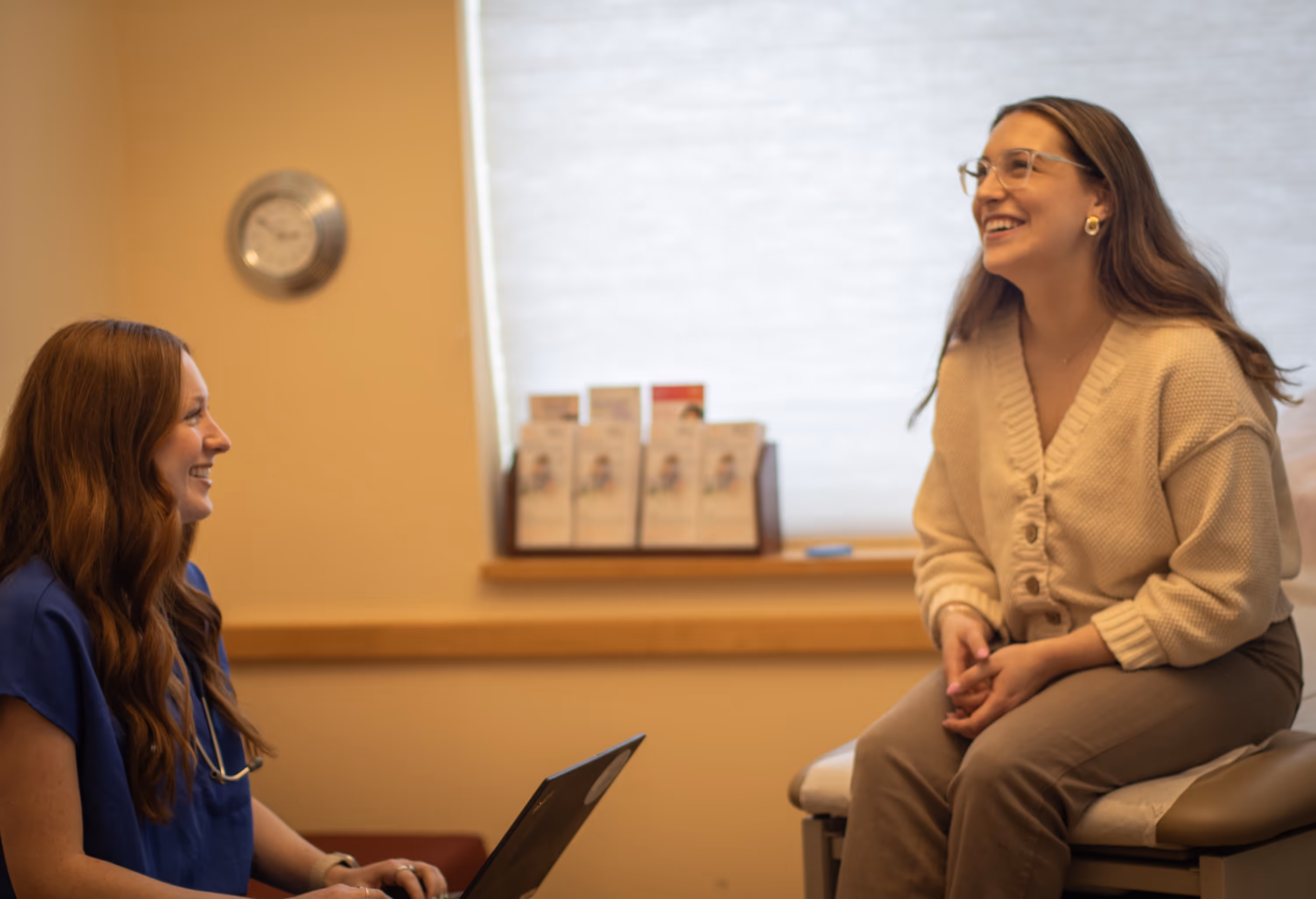 Smiling healthcare professional with patient in warm medical consultation room