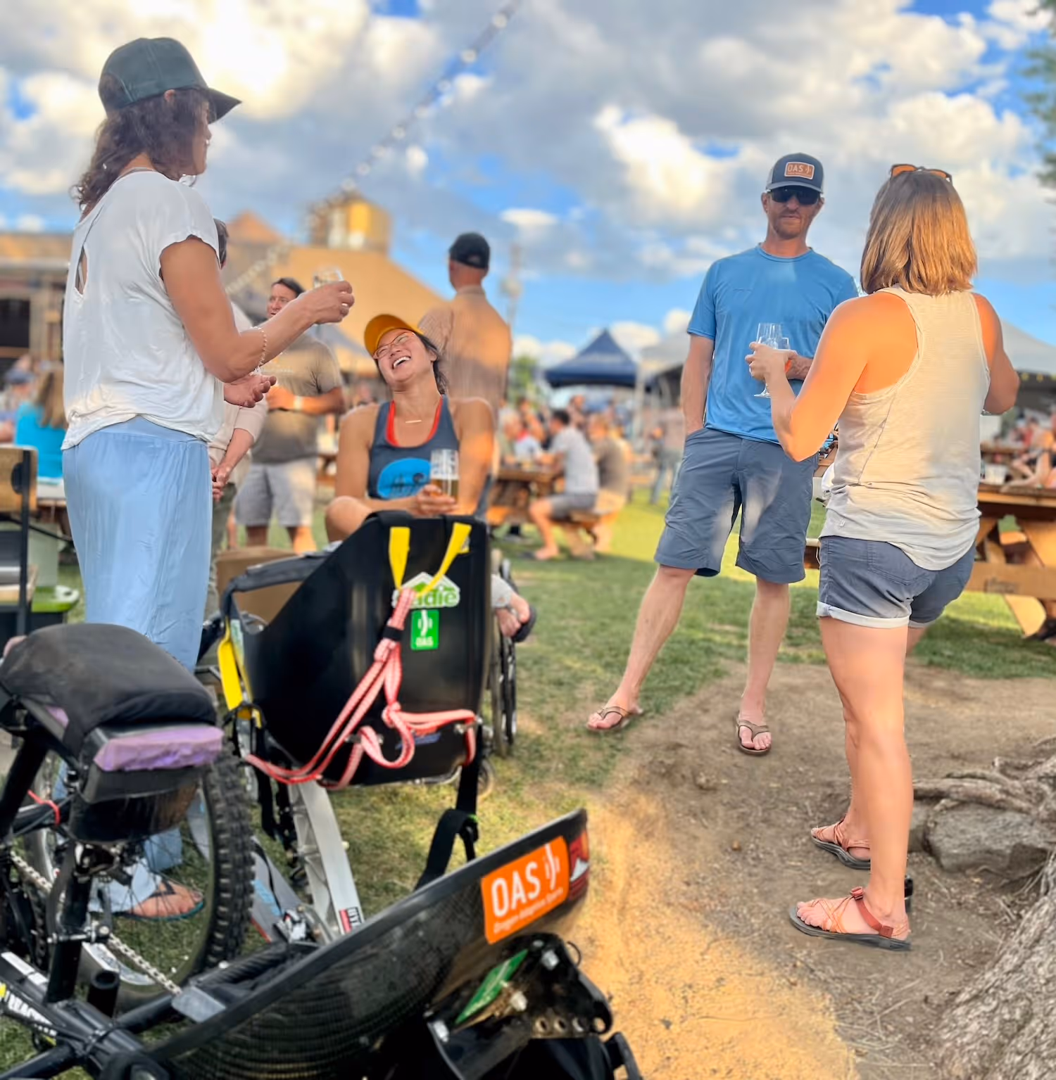 A group of people standing around a bike.