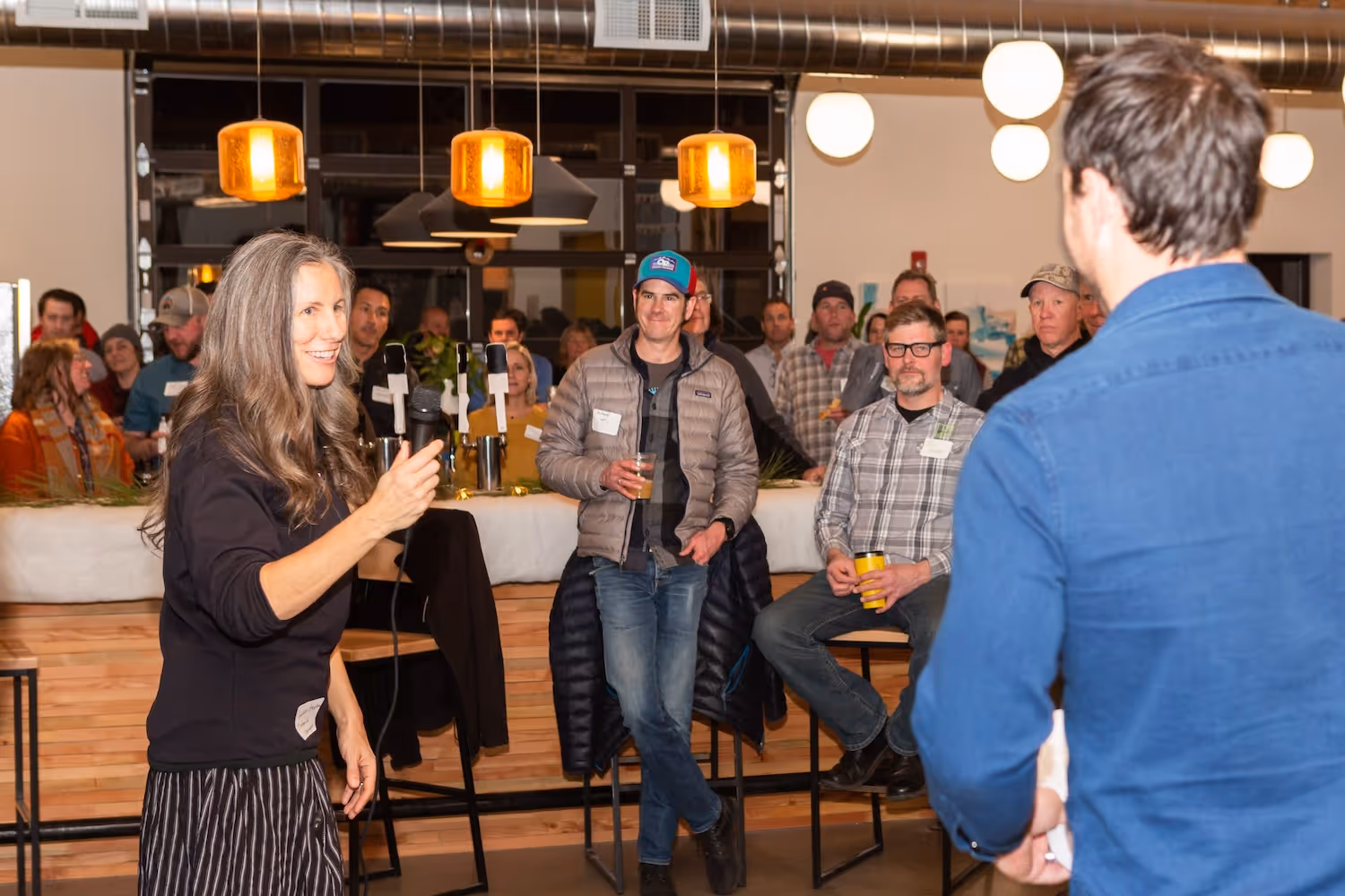 A woman standing in front of a crowd of people.