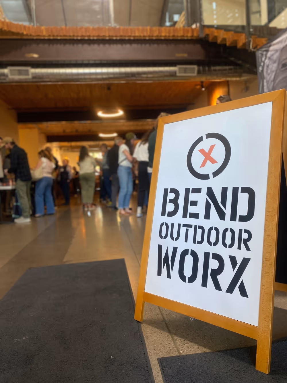 A sign that says bend outdoor work on it.