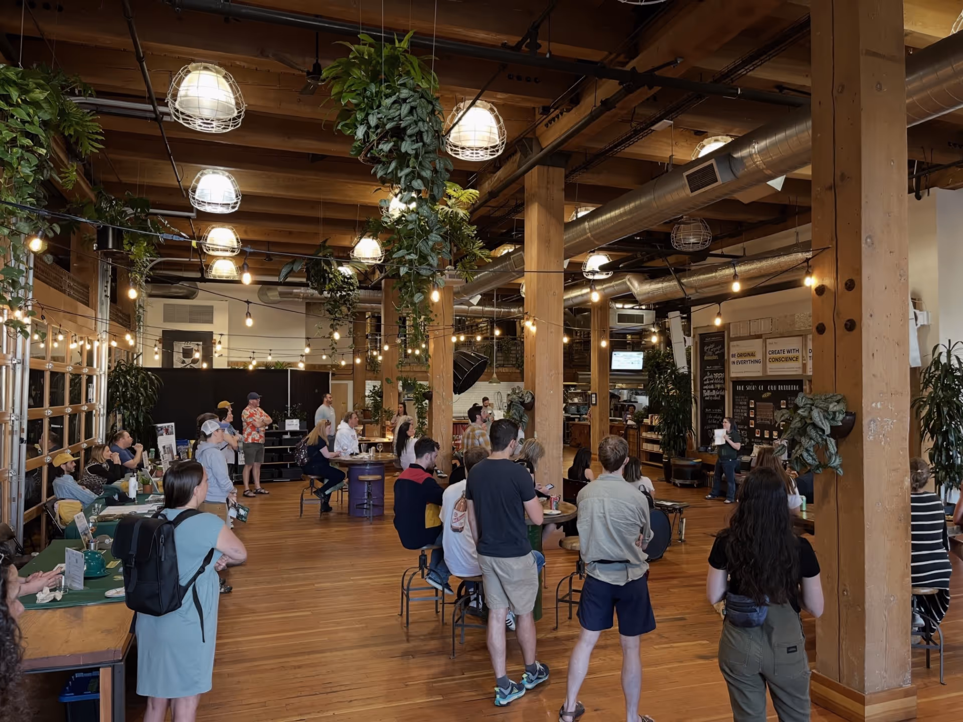A group of people standing around a wooden floor.
