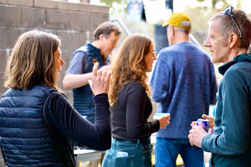 A group of people standing around each other.