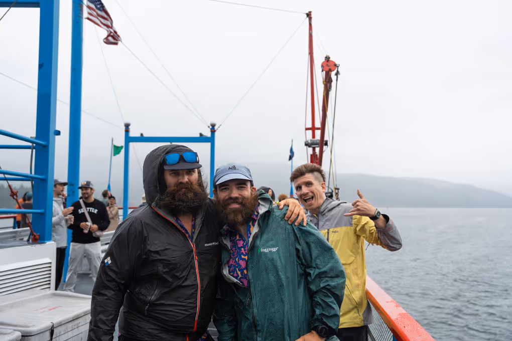 Three men on a boat posing for a picture.