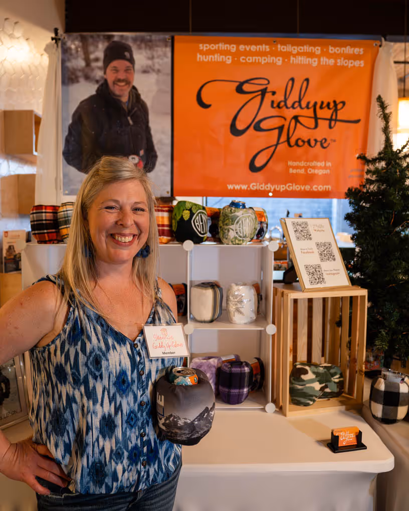 A woman standing in front of a display of hats.