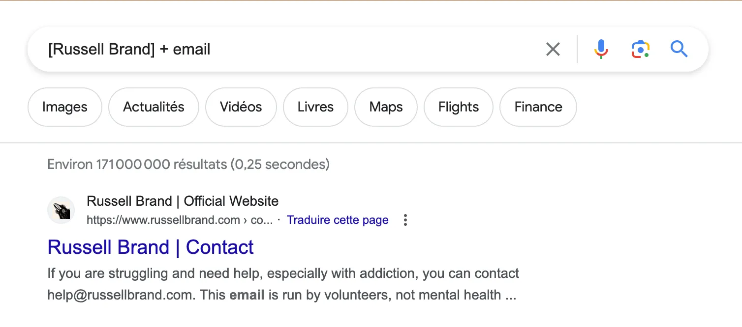 A screen shot of a web page with a description for russell brand contact.