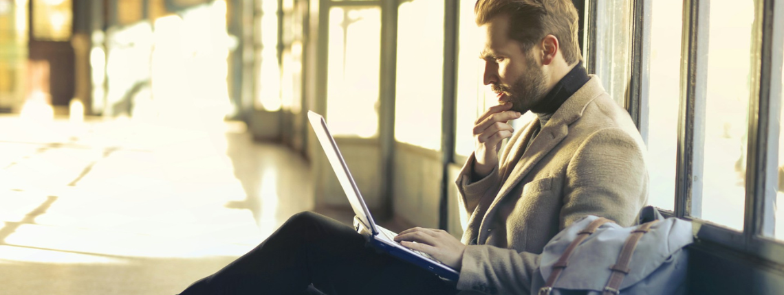 Early-stage founder sitting by a window, deep in thought with a laptop — symbolising figuring things out step by step.