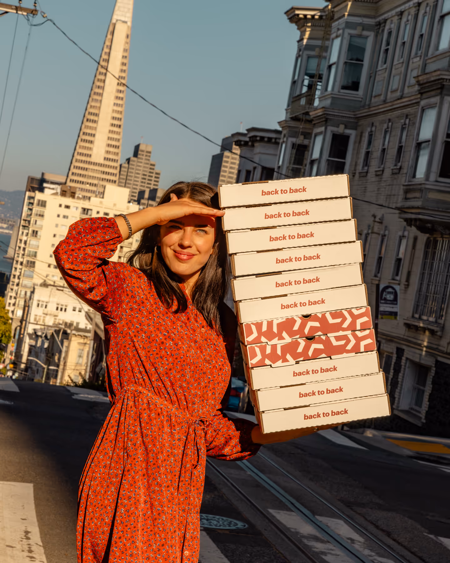 Alyssa carrying pizza boxes