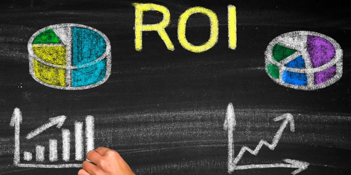 hand drawing roi charts and pies on a blackboard