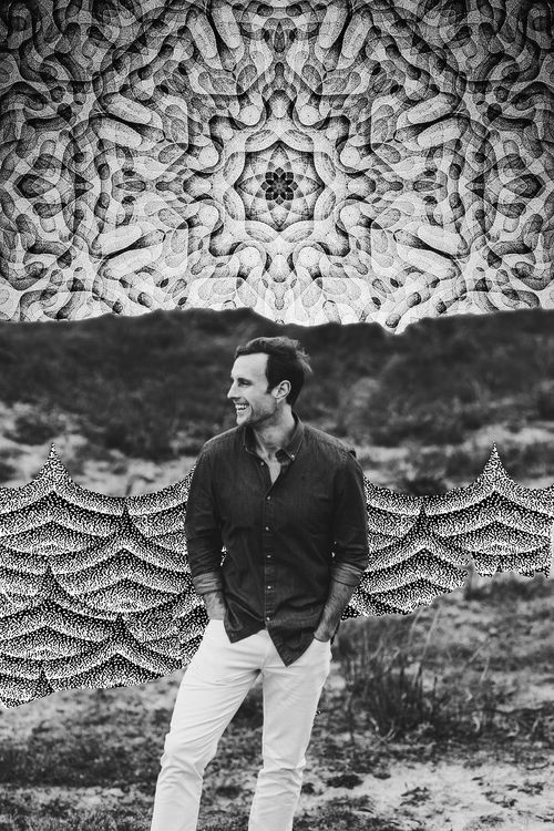 Mike Pinette standing in nature beside a large-scale mural, blending art and landscape in meditative tones