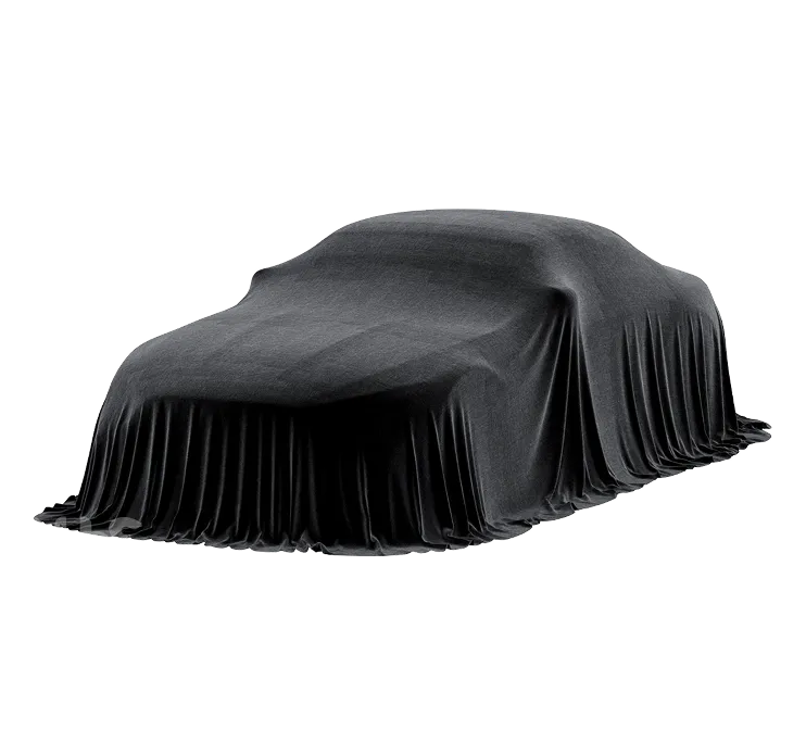 Auto zakryté tmavě šedou látkou připravené k odhalení.