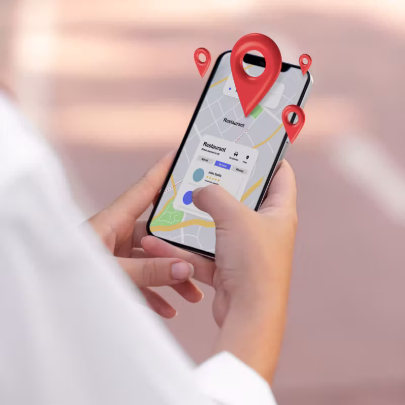 Hand holding phone showing MapCosmos store locator with map and location pins during setup process