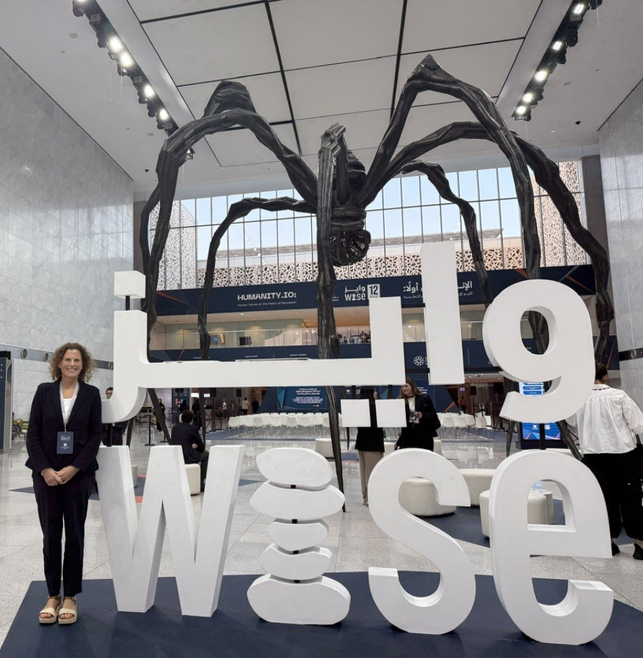A person standing in front of a large sculptureAI-generated content may be incorrect.