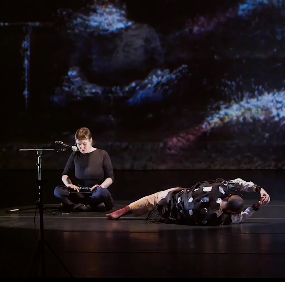 Maria performing with another person on stage