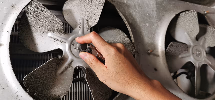 A technician servicing fan blades.