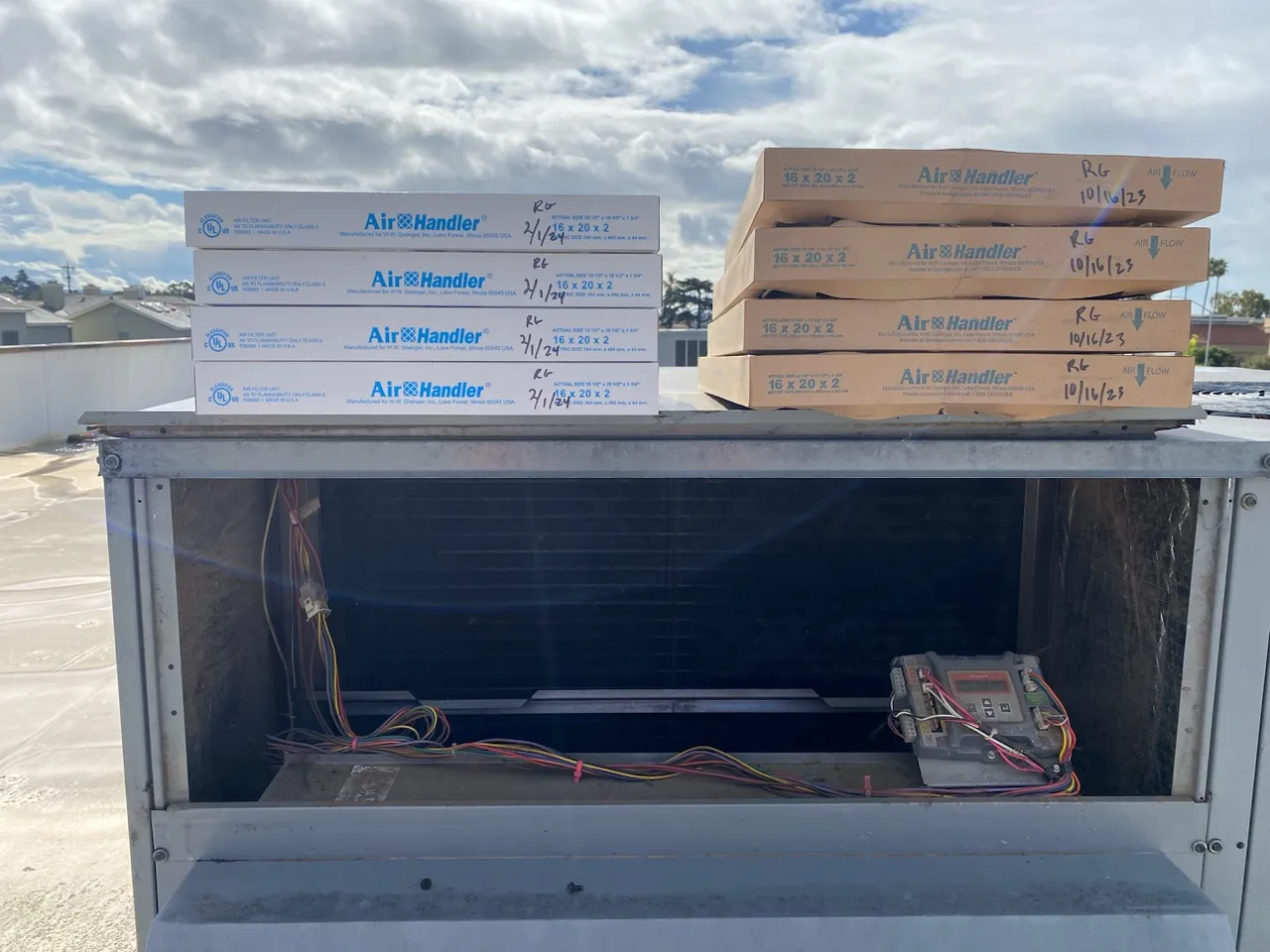 Air Handler filter boxes are stacked on an HVAC unit, showcasing preparation for maintenance work.
