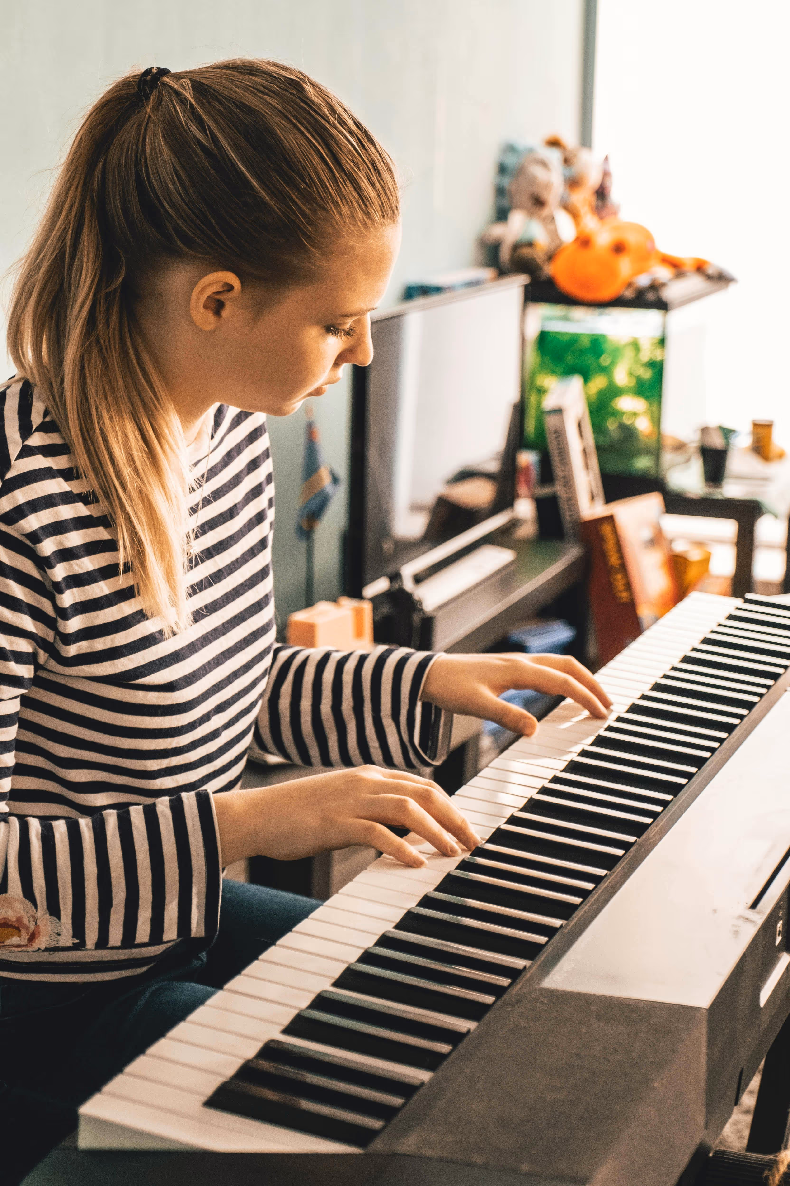 young female playing piano in studio