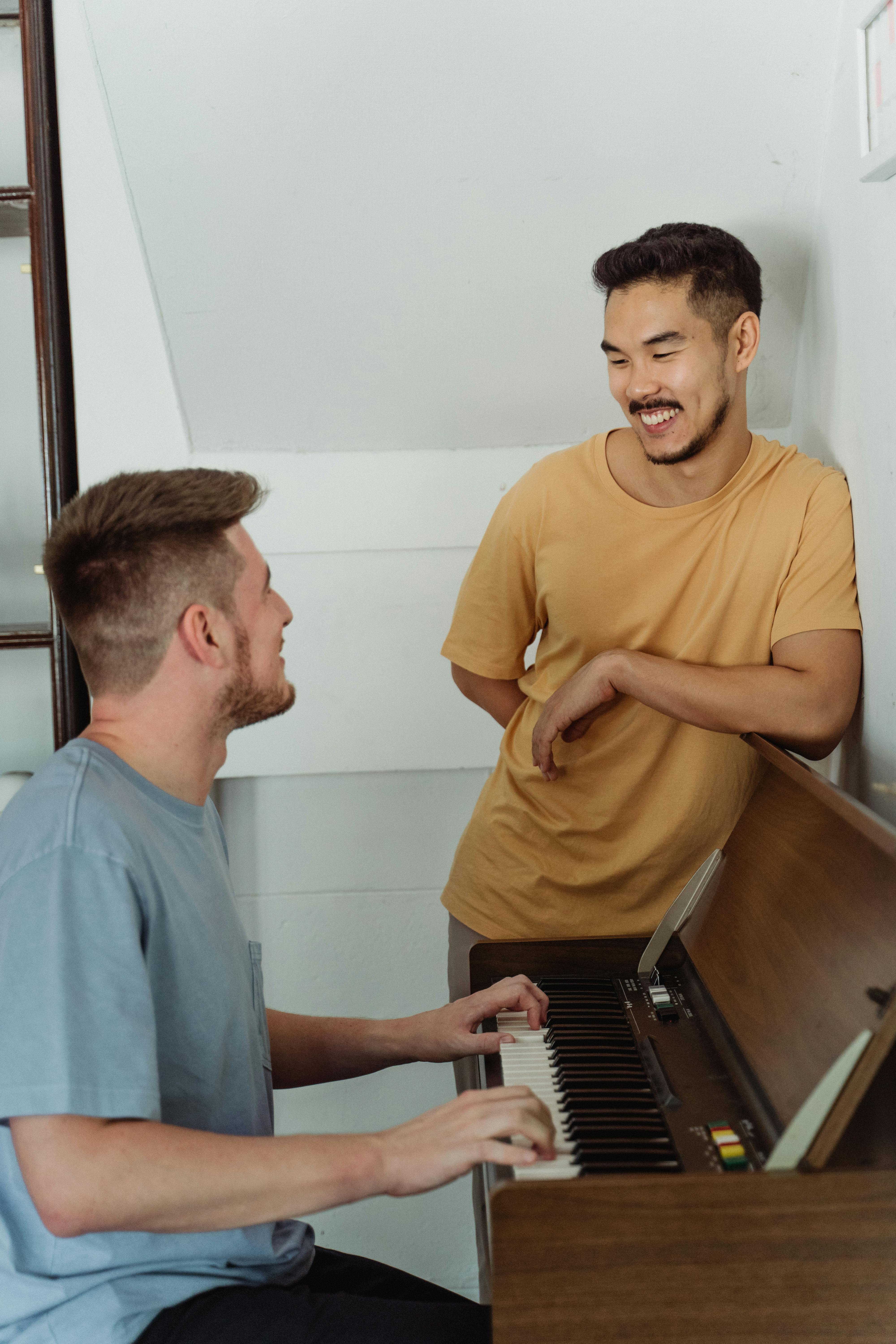 adult playing piano enjoying social conversation
