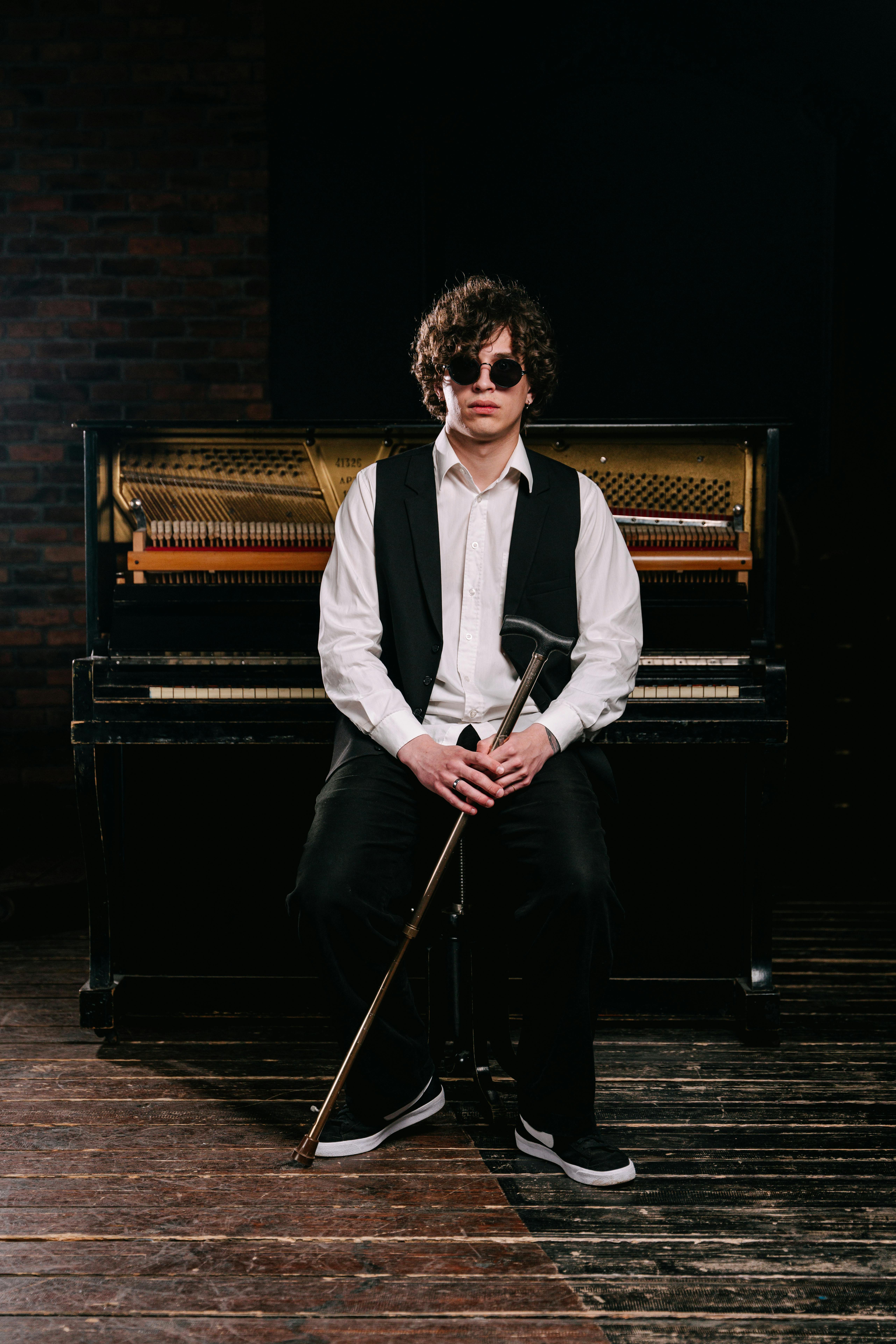 confident young adult sitting at piano