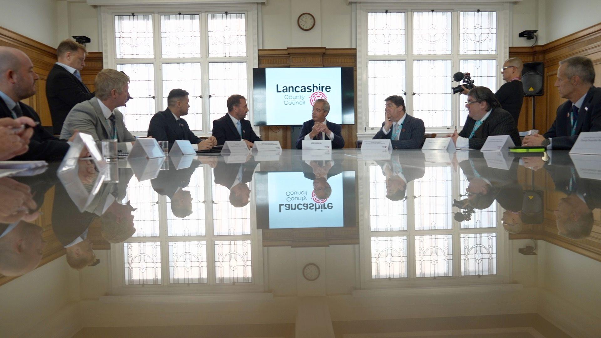 Lancashire County Council meeting with officials around a reflective conference table