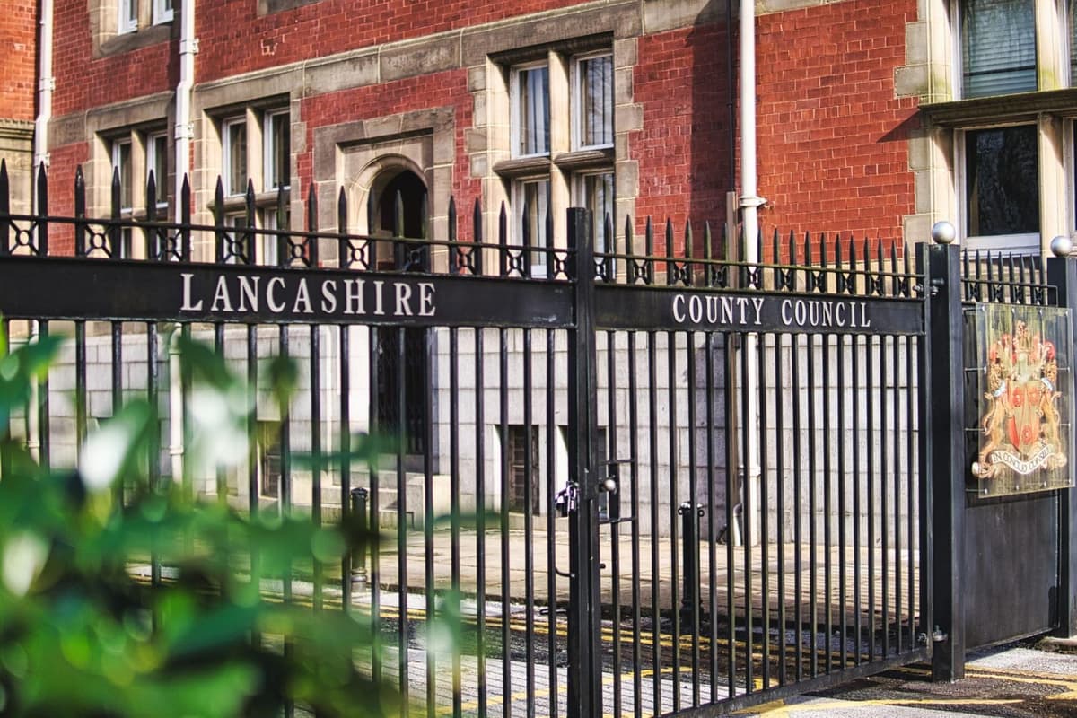 Entrance gates to Lancashire County Council building with red brick facade