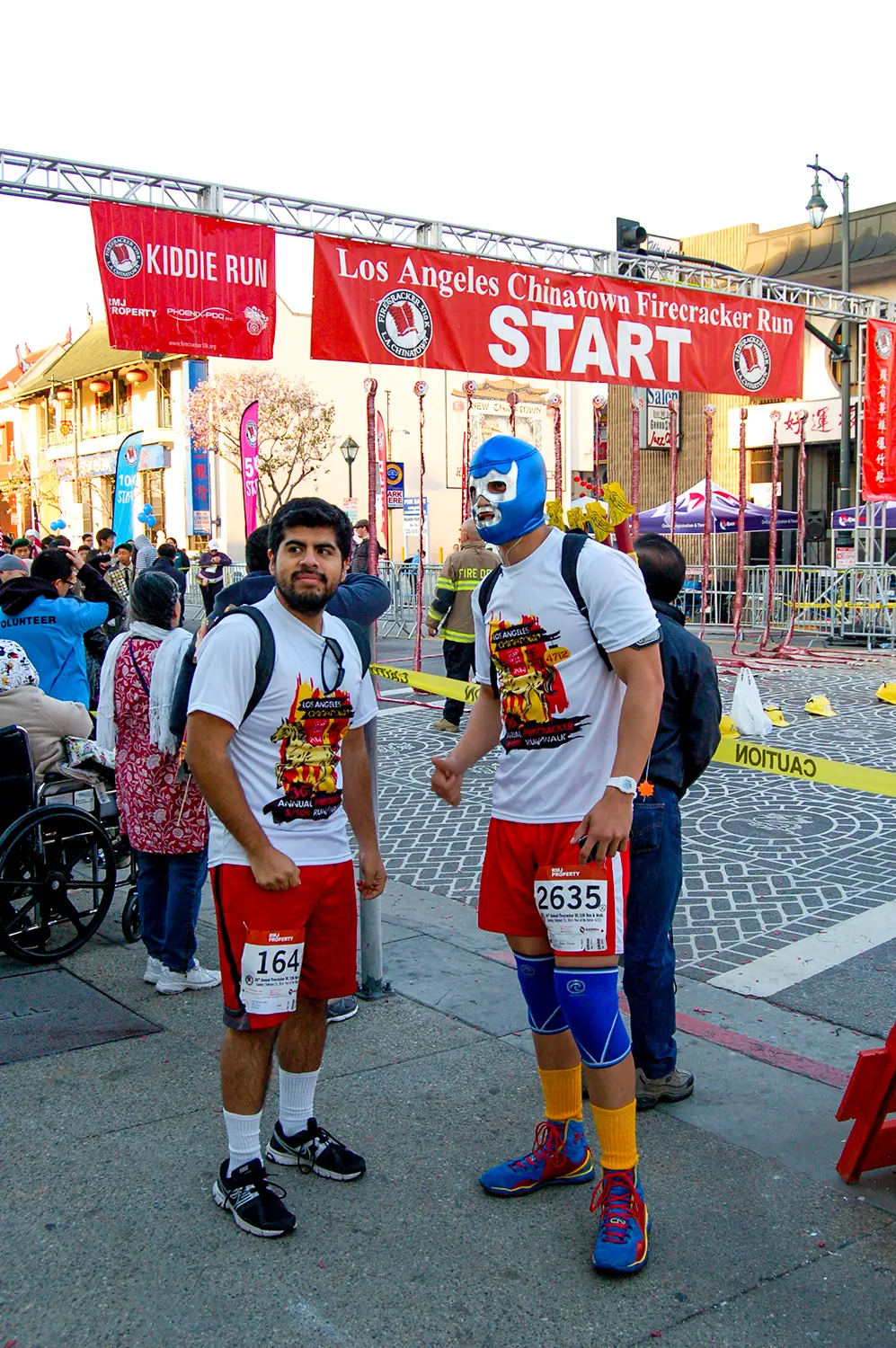 LA Chinatown Firecracker Run graphic designed by Loc Tran. Runners wearing race shirts with Loc's design on it.
