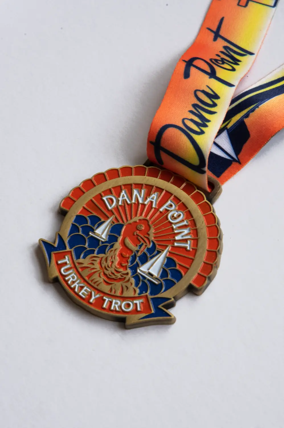 Dana Point Turkey Trot Age Group medal designed by Loc Tran.